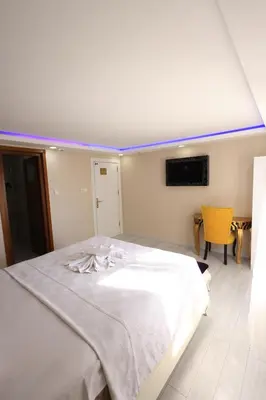 a bedroom with a white bed with a blue ceiling at HamzaBey Hotel in Istanbul
