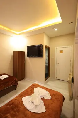 a hotel room with a robe on a bed at HamzaBey Hotel in Istanbul