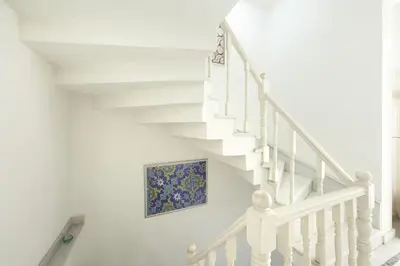 a white staircase with a painting on the wall at Pi Art Butik Otel in Istanbul