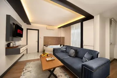 a living room with a couch and a table at Bakırköy Zeugma Suit Otel in Istanbul