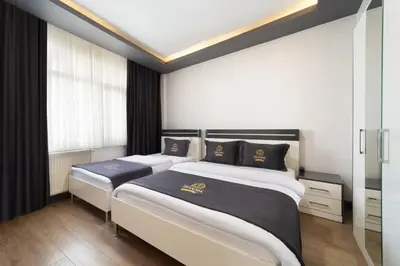 a bedroom with two beds and a window at Bakırköy Zeugma Suit Otel in Istanbul
