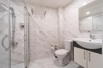 a bathroom with a toilet and a sink and a shower at Bakırköy Zeugma Suit Otel in Istanbul