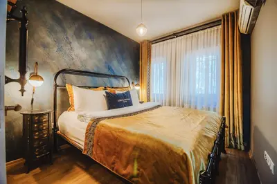 a bedroom with a bed and a large window at Lord Morgan & Exclusive Design Residence Nişantaşı in Istanbul