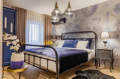 a bedroom with a bed with purple sheets and a wall with drawings at Lord Morgan & Exclusive Design Residence Nişantaşı in Istanbul