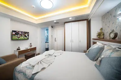 a bedroom with a large white bed in a room at Lika Hotel in Istanbul