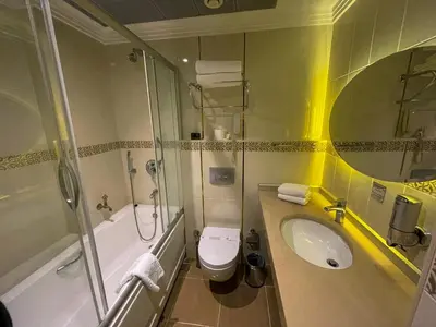 a bathroom with a sink and a toilet and a shower at Black Bird Thermal Hotel & SPA in Gokcedere