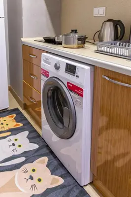 a washing machine in a kitchen next to a counter at Oval Flats Old City in Istanbul