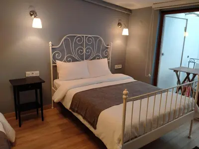 a bedroom with a bed with a metal headboard at Oval Flats Old City in Istanbul