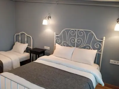 a bedroom with two beds with white pillows at Oval Flats Old City in Istanbul