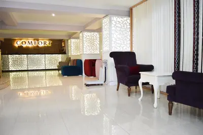 a lobby with a chair and a table and a sign at Comfort Downtown Istanbul Hotel in Istanbul