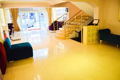a living room with a staircase and a couch and chairs at Comfort Downtown Istanbul Hotel in Istanbul