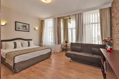 a hotel room with a bed and a couch at Taxim Hotel Marin in Istanbul