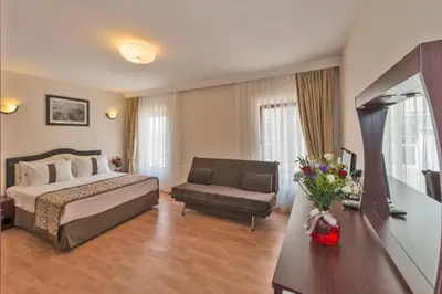 a hotel room with a bed and a couch at Taxim Hotel Marin in Istanbul