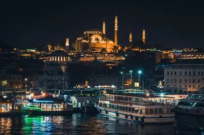 a view of a city at night with boats in the water at Hotel Gritti Pera & Spa in Istanbul