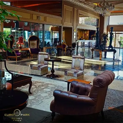 a lobby with chairs and tables in a building at Euro Park Otel in Istanbul