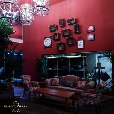 a living room with a couch and clocks on the wall at Euro Park Otel in Istanbul
