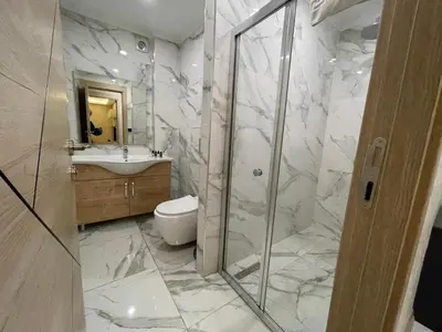 a bathroom with a shower and a toilet and a sink at Le Luxe Suites Hotel in Bursa