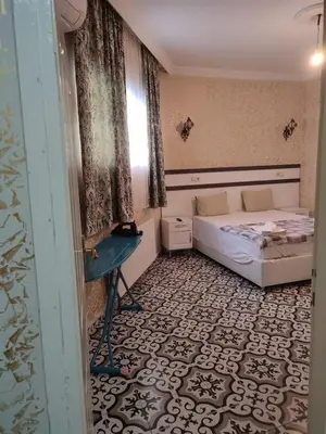a small bedroom with a bed and a window at Old City Pansiyon in Istanbul