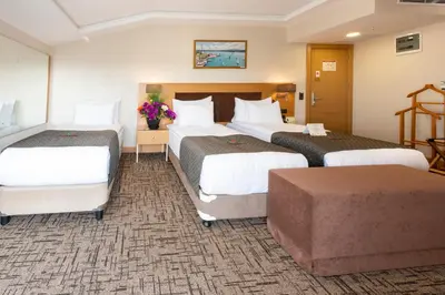 a hotel room with two beds and a couch at Hotel Boursier 2 & Spa in Istanbul