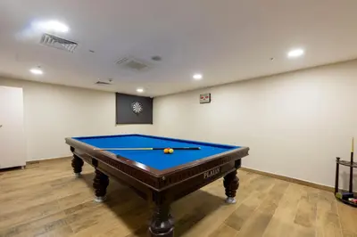 a pool table in a room with a wall at Hotel Boursier 2 & Spa in Istanbul