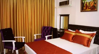 a hotel room with a bed and two chairs at Hotel Kuk in Istanbul
