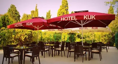 a restaurant with tables and chairs and umbrellas at Hotel Kuk in Istanbul