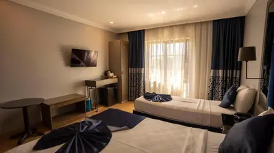 a hotel room with two beds and a window at Farina Hotel By Cigno in Istanbul