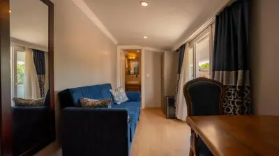 a living room with a blue couch and chairs at Farina Hotel By Cigno in Istanbul