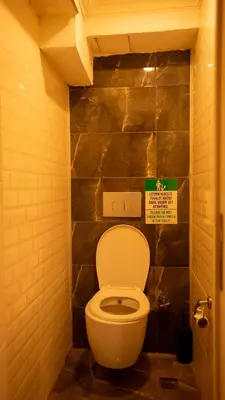 a bathroom with a toilet with a sign above it at Farina Hotel By Cigno in Istanbul