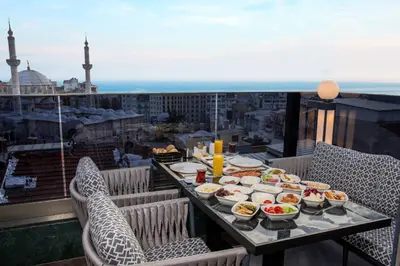 a table with food on a balcony with a view at Beethoven Senfoni Hotel in Istanbul