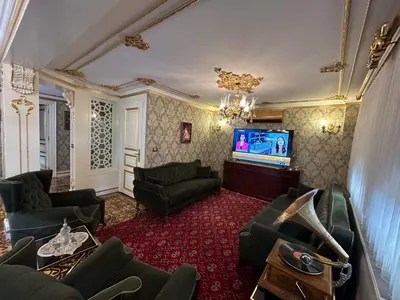 a living room with a couch and a tv at TAHTAKALE KONAK HOTEL Private & Luxury in Bursa