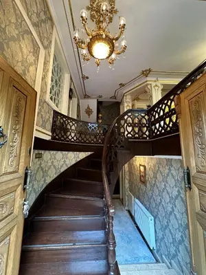 a spiral staircase in a house with a chandelier at TAHTAKALE KONAK HOTEL Private & Luxury in Bursa