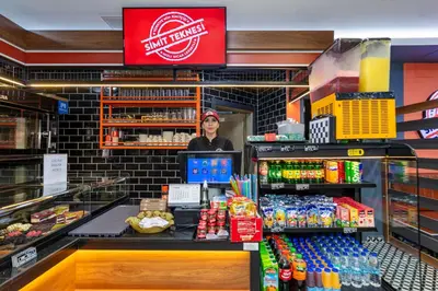 a woman standing behind the counter of a store at Dem İstanbul Airport Hotel in Istanbul