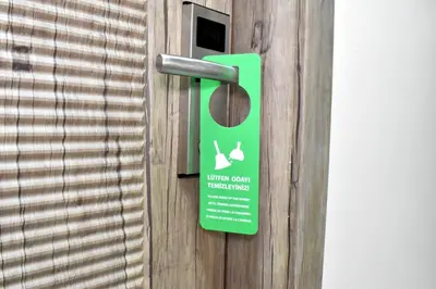 a green sign on a door with a window at Dem İstanbul Airport Hotel in Istanbul
