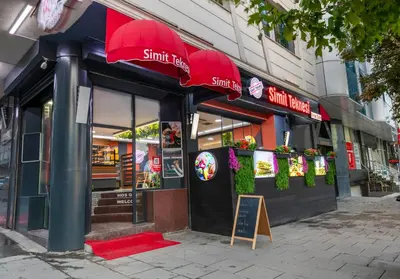 a fast food restaurant with red umbrellas on a street at Dem İstanbul Airport Hotel in Istanbul