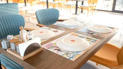 a wooden table with plates on top of it at Yalıköy Deniz Otel Istanbul in Yalıköy