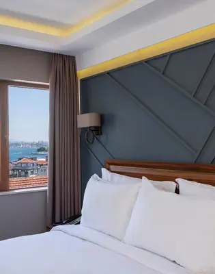 a hotel room with a bed and a window at Azzap Hotel Galata in Istanbul