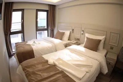 a hotel room with two beds and a window at X-NELLYİ HOTEL in Istanbul