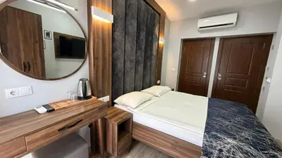 a small bedroom with a bed and a mirror at Han Suite Hotel in Istanbul