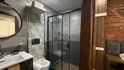 a bathroom with a shower and a sink and a toilet at Han Suite Hotel in Istanbul