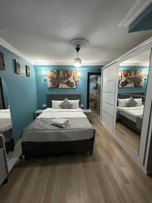 a bedroom with two beds and a large mirror at Ada Apart Hotel in Istanbul