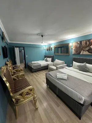 a large room with two beds and a couch and a couch at Ada Apart Hotel in Istanbul