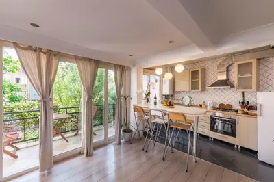 a kitchen with a table and chairs and a balcony at Istanbul Amedros Home in Istanbul