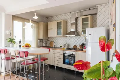 a kitchen with a white refrigerator and a table at Istanbul Amedros Home in Istanbul