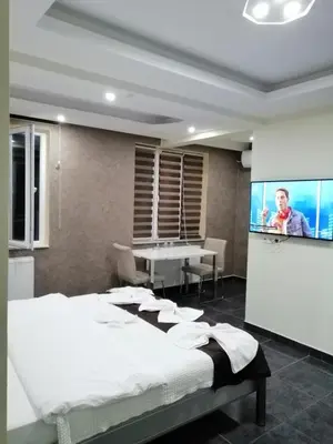 a bedroom with a bed and a flat screen tv at KILIÇ MOTEL in Istanbul