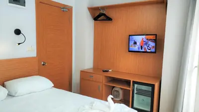 a bedroom with a bed and a tv on a wall at Cheers Lighthouse in Istanbul