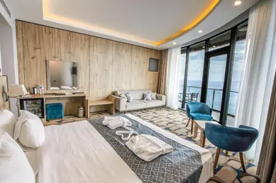 a hotel room with a bed and a desk at BLUE MUDANYA HOTEL in Bursa