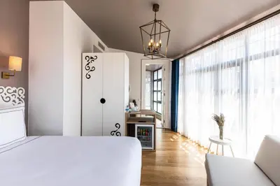 a bedroom with a white bed and a fireplace at Petros Hotel in Istanbul