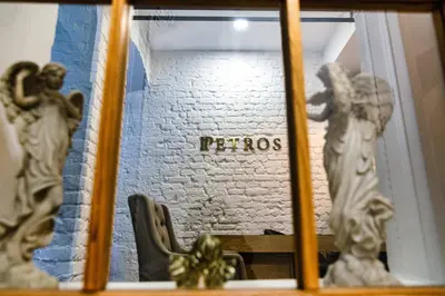 a window with a statue of two statues on a wall at Petros Hotel in Istanbul