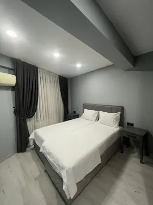 a bedroom with a large bed with white sheets at Seaway Hotel İstanbul in Istanbul
